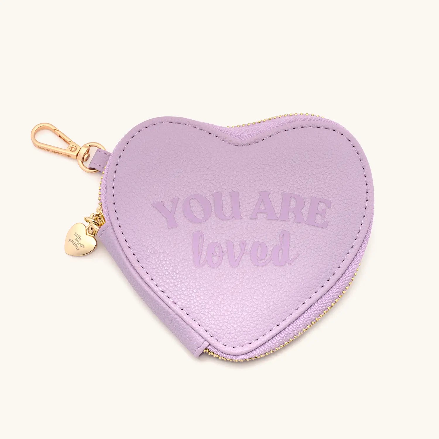 Heart-shaped purple pouch with 'YOU ARE LOVED' text and gold zipper on a white background