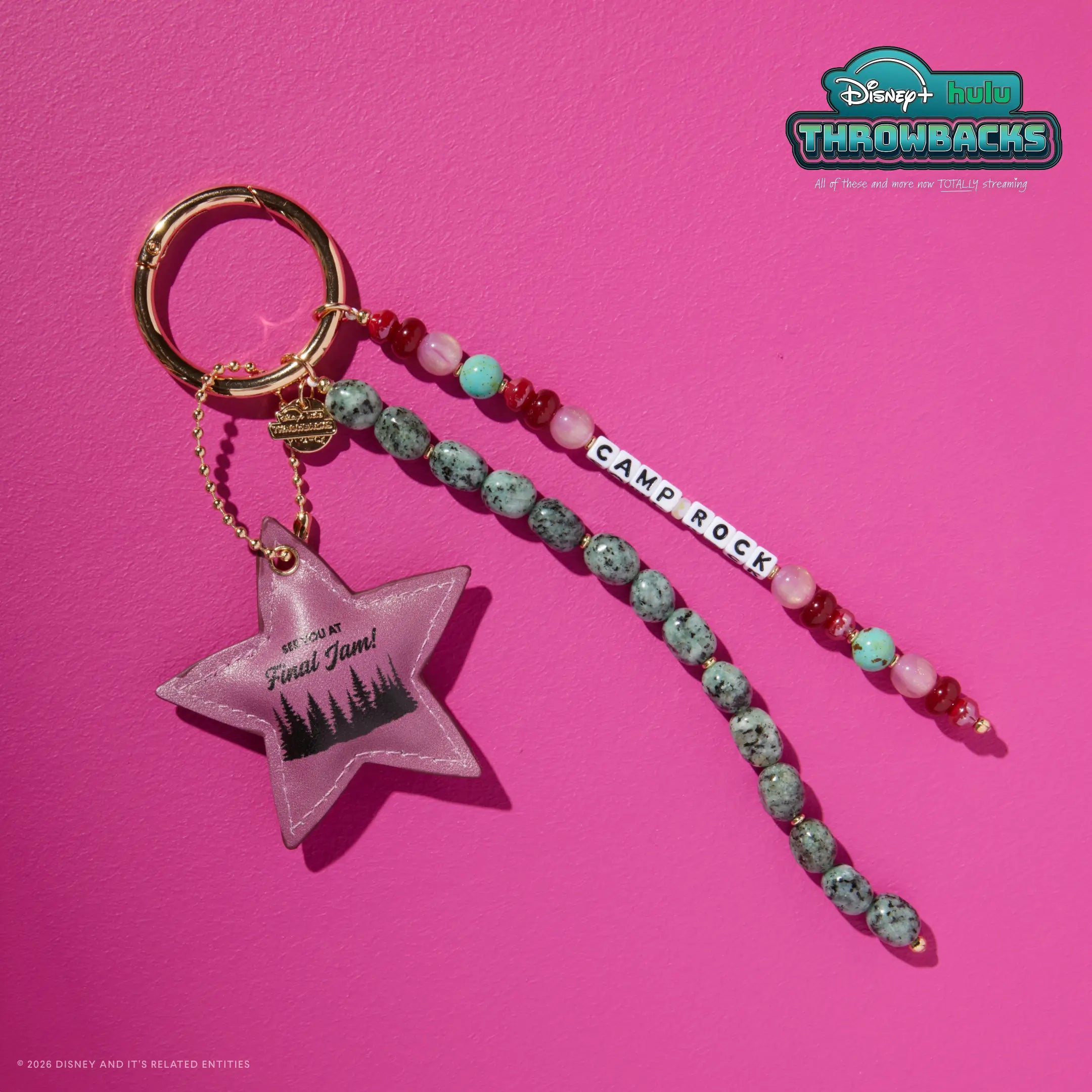 Camp Rock Disney+ Hulu Throwbacks bag charm on a hot pink background showing the faux leather star charm and beaded strands