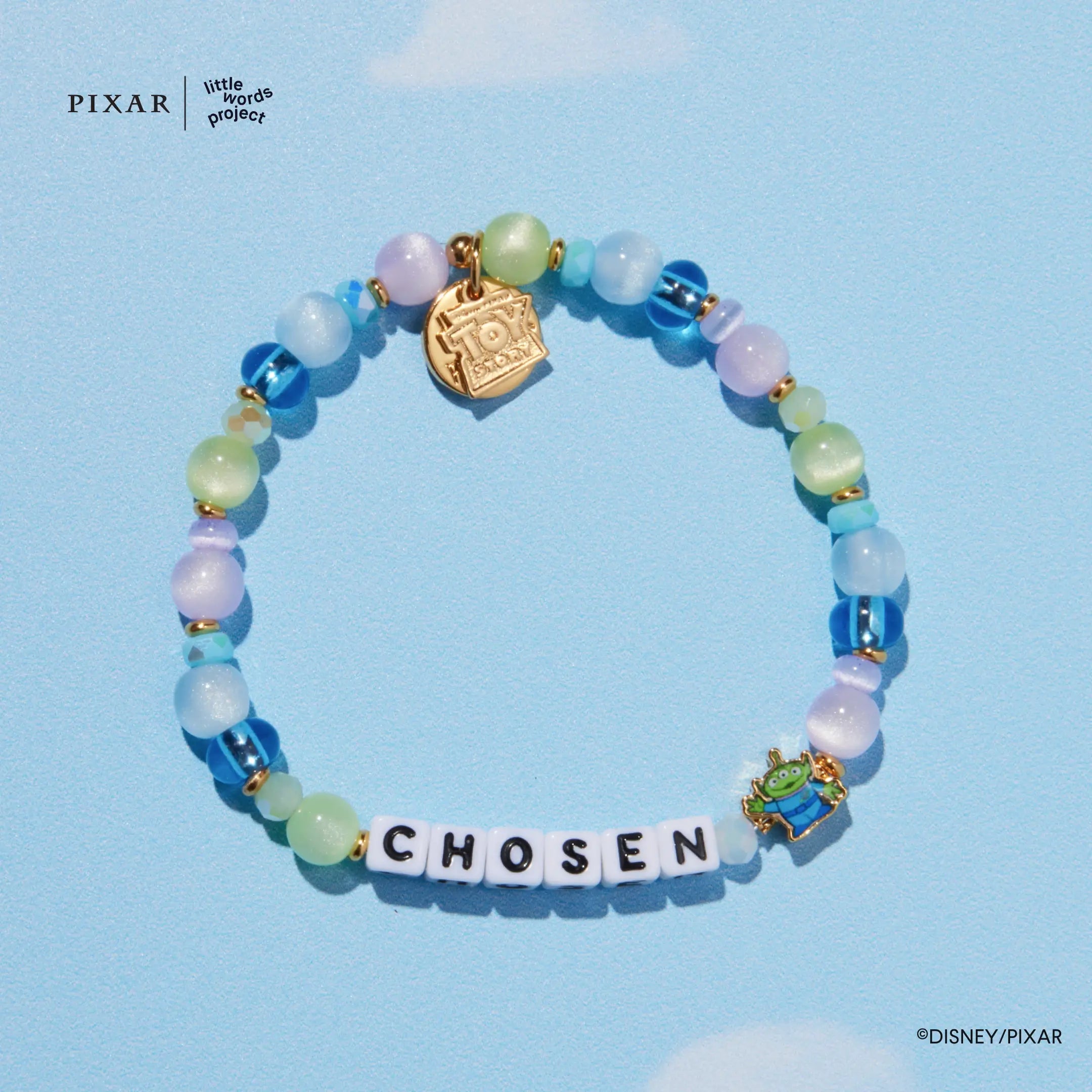Chosen Toy Story bracelet, pastel beads with a gold charm, on a blue background