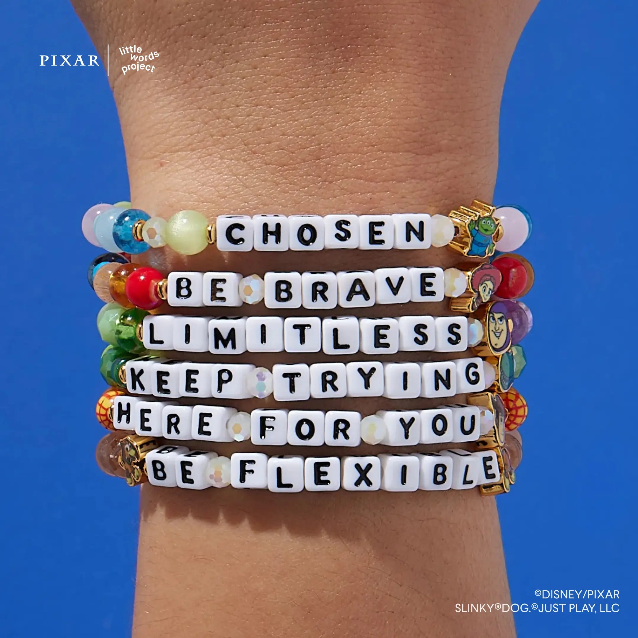 Deluxe Toy Story six-bracelet set worn stacked on a model's wrist, blue background