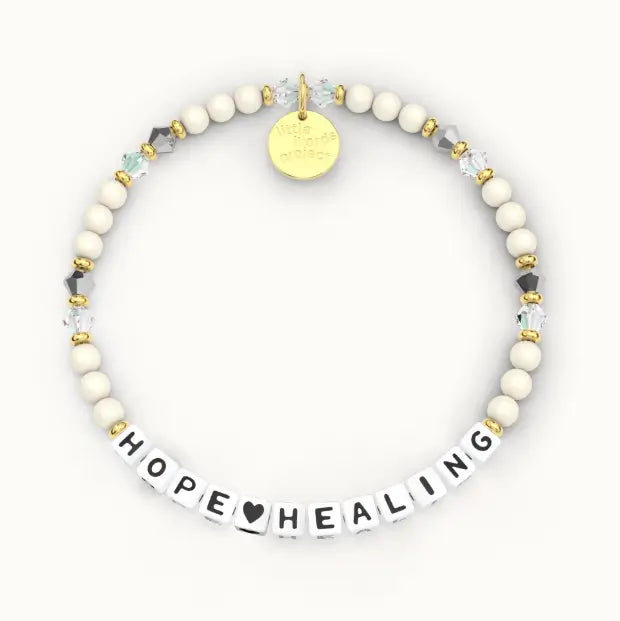 Giveback Hope Heart Healing bracelet with cream ivory beads and crystal accents, gold hardware, flat-lay product shot