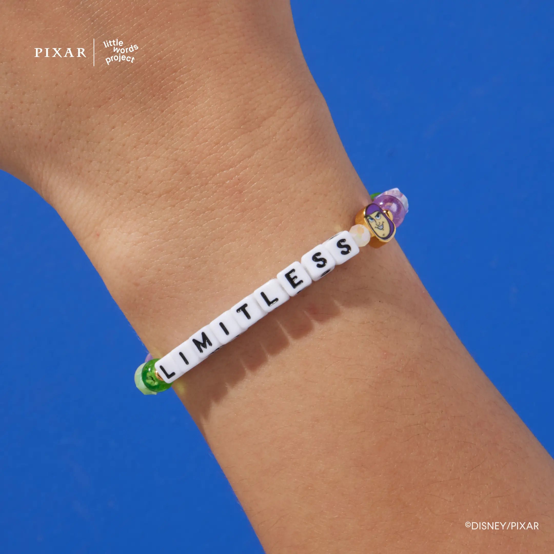 Limitless Toy Story bracelet worn on a model's wrist against a blue background