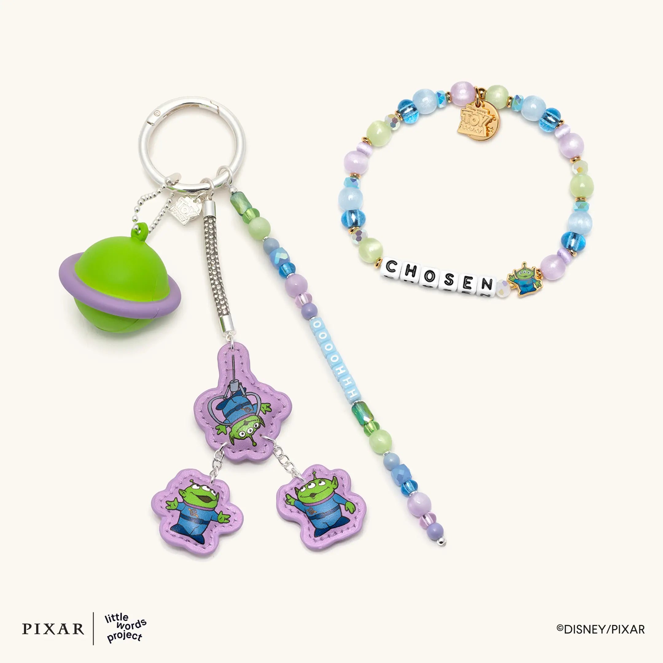 Oooohhhh Alien Set, alien keychain charm and Chosen Toy Story bracelet, flat lay