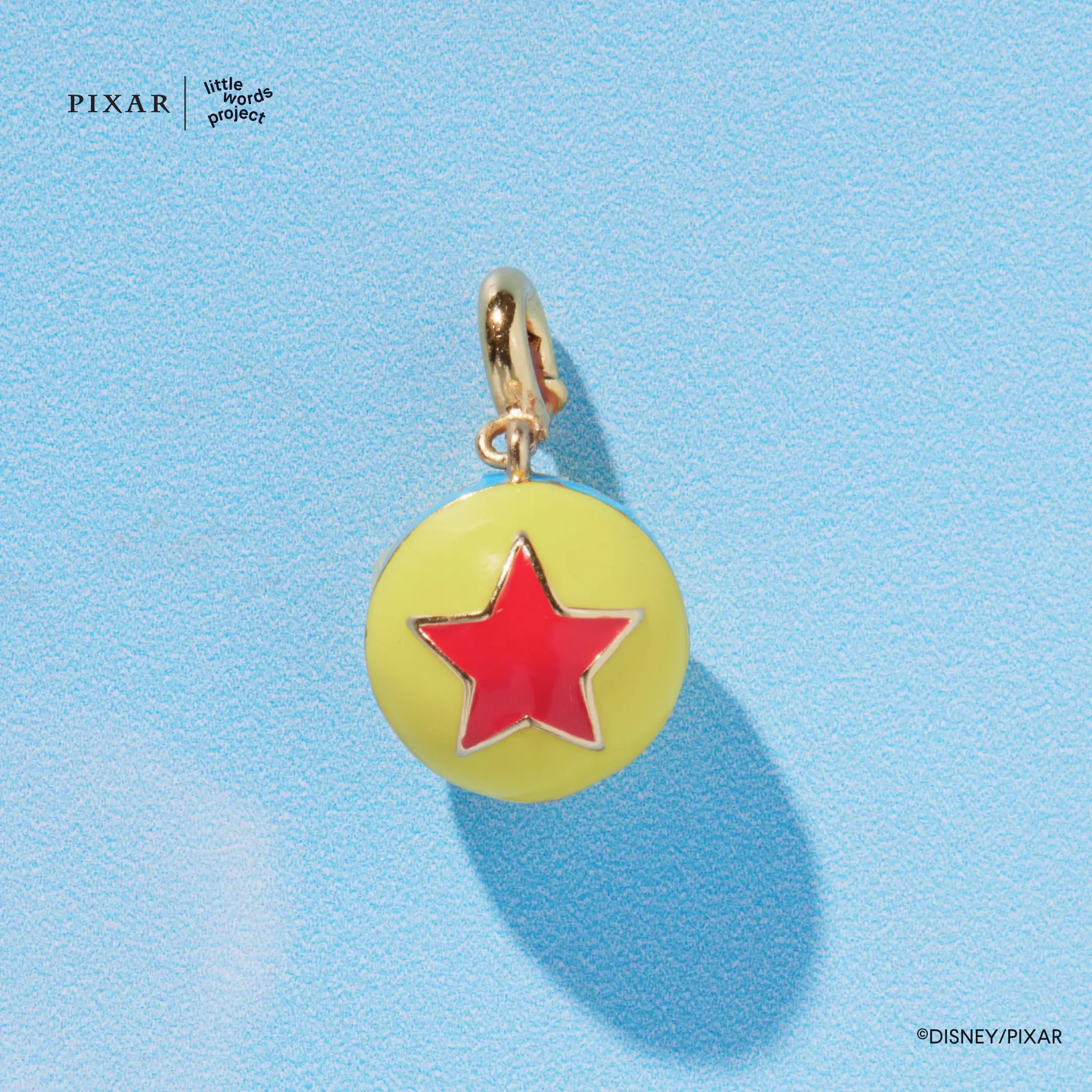 Pixar ball charm with a red star from the Reach for the Sky Toy Story set, detail on blue