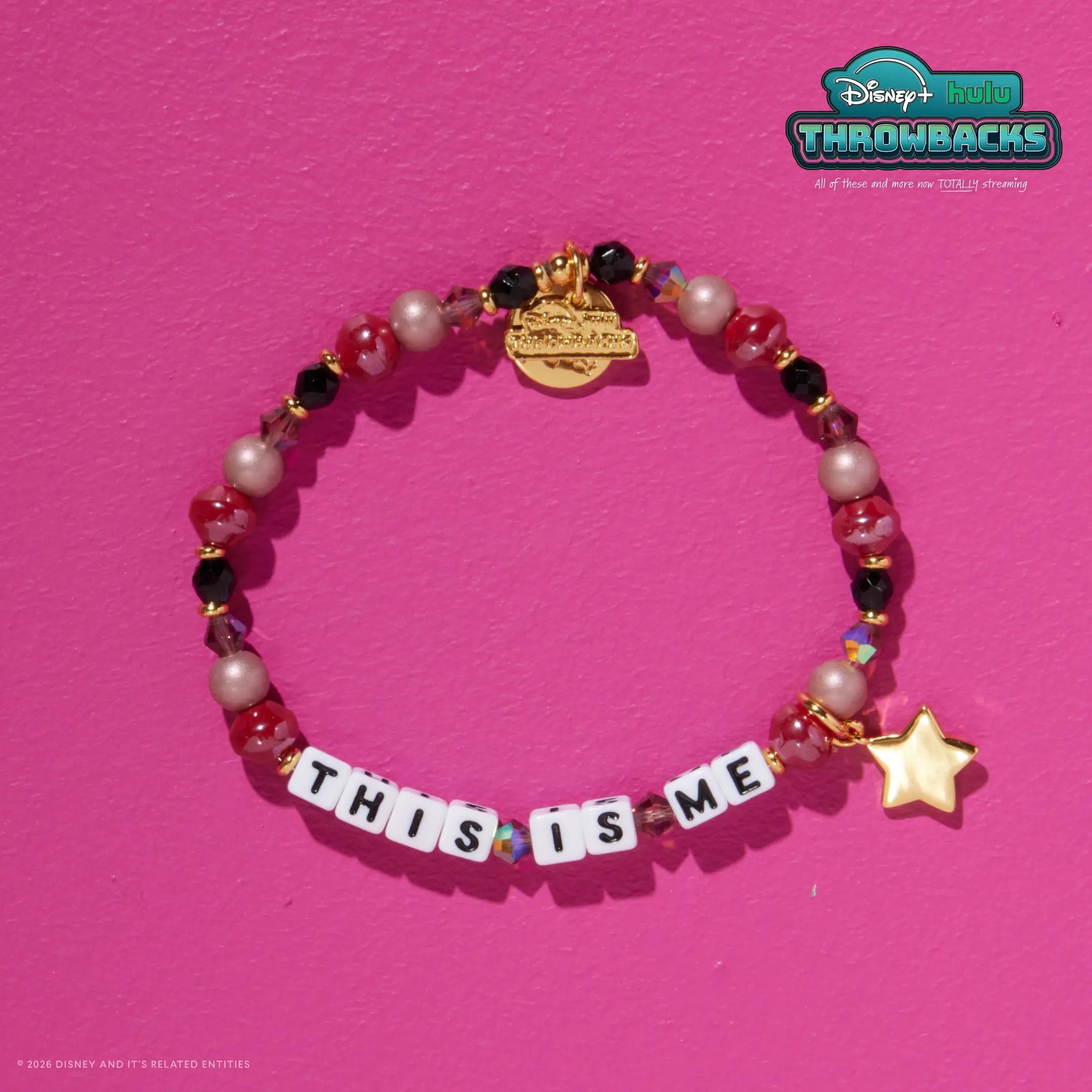 This Is Me Disney+ Hulu Throwbacks bracelet on a hot pink background showing the gold star charm and Throwbacks logo tag