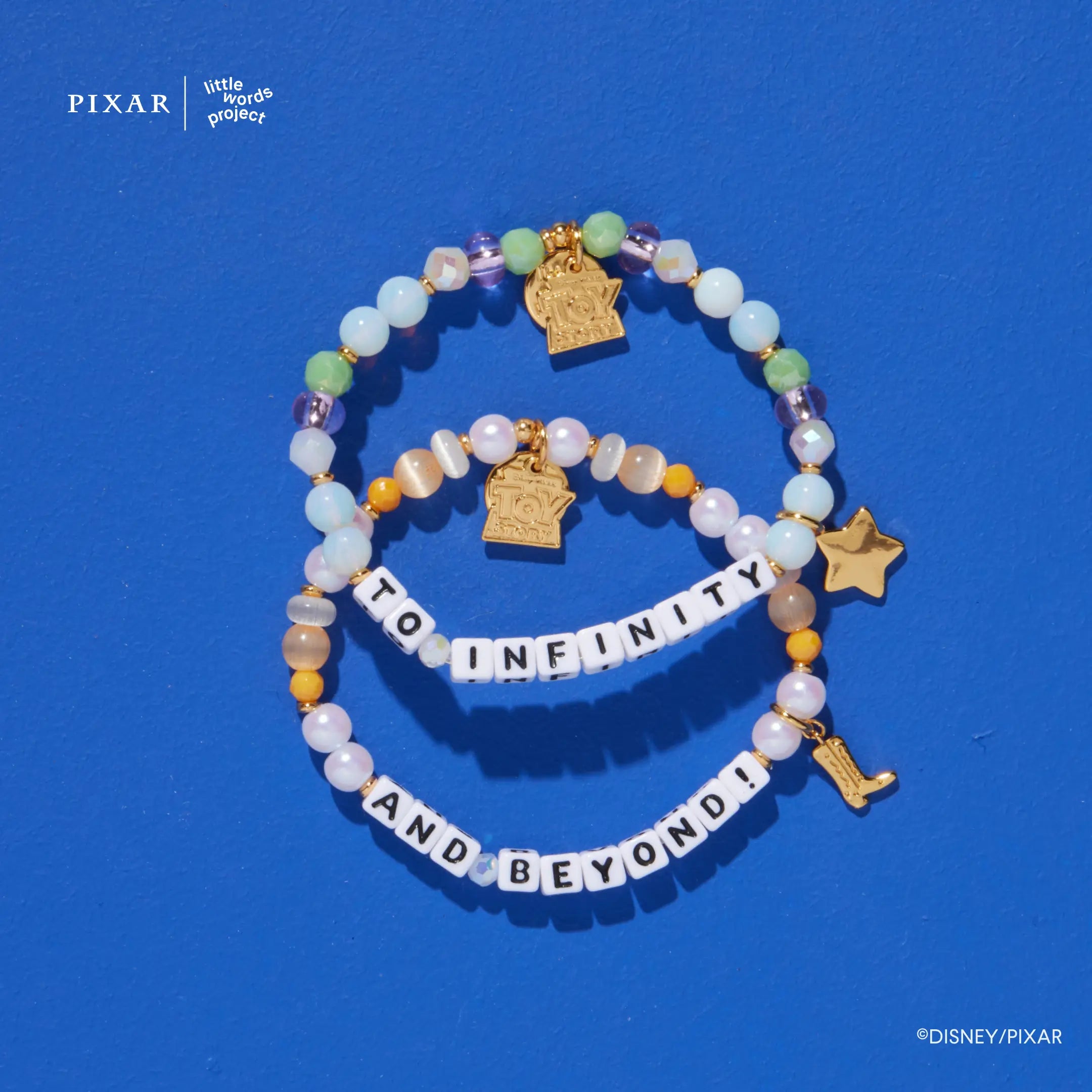 To Infinity and Beyond two-bracelet Toy Story set with gold charms on a blue background