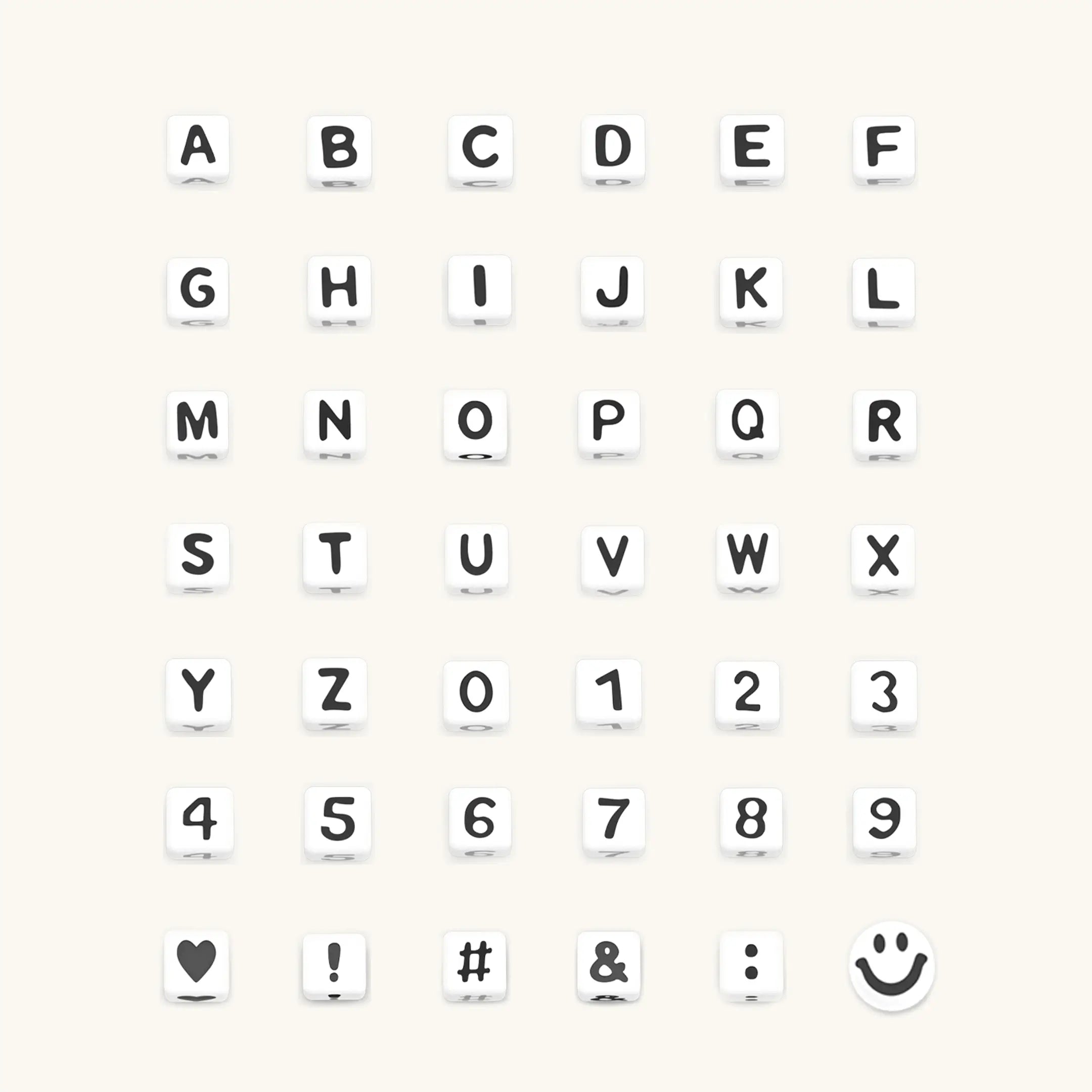 Set of white letter blocks with letters A-Z, numbers 0-9, and symbols on a white background